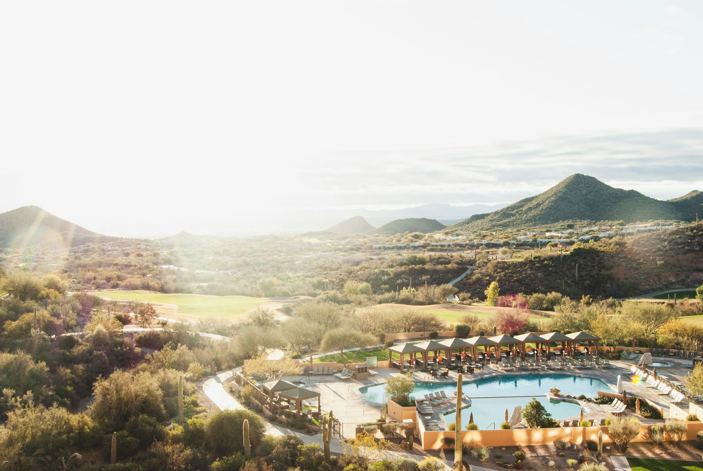 Resort pool in a desert valley under warm last light