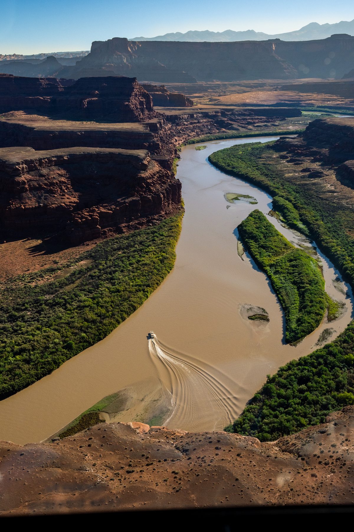 A boat leaves a wake on the Colorado River seen from above