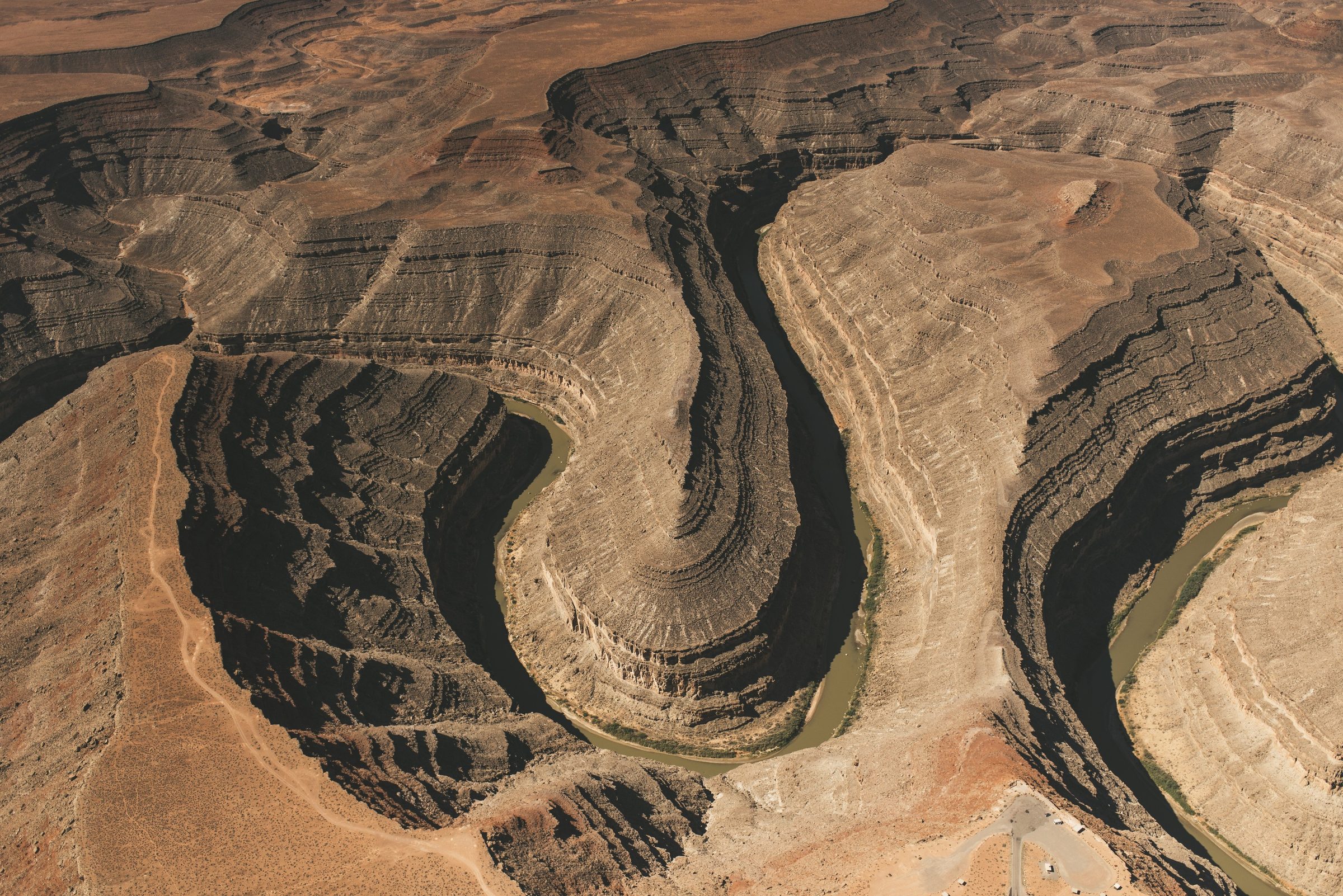 Aerial view of a river meander carved deep into layered rock