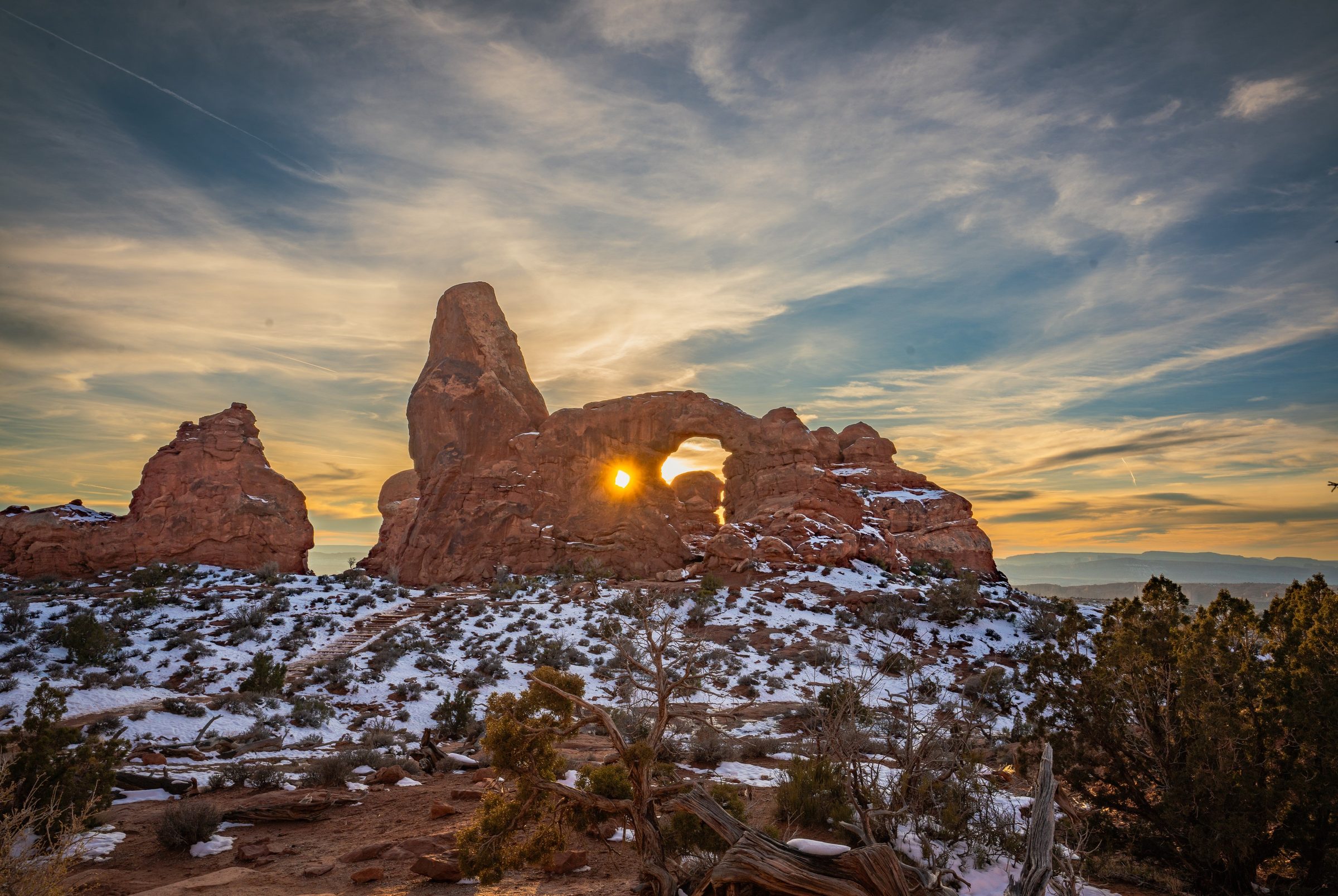 Turret Arch at sunset with snow on the ground